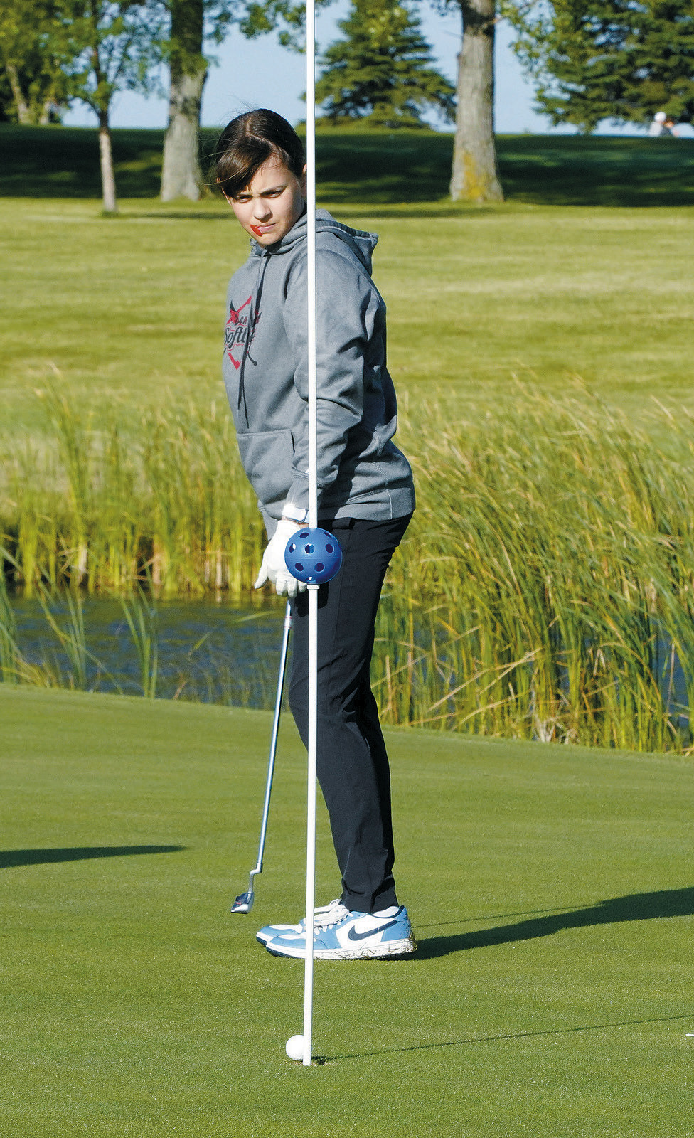Lily Zimmer focuses in to sink a putt at Lakota on Sept. 6. Photo by Larry Stokke.