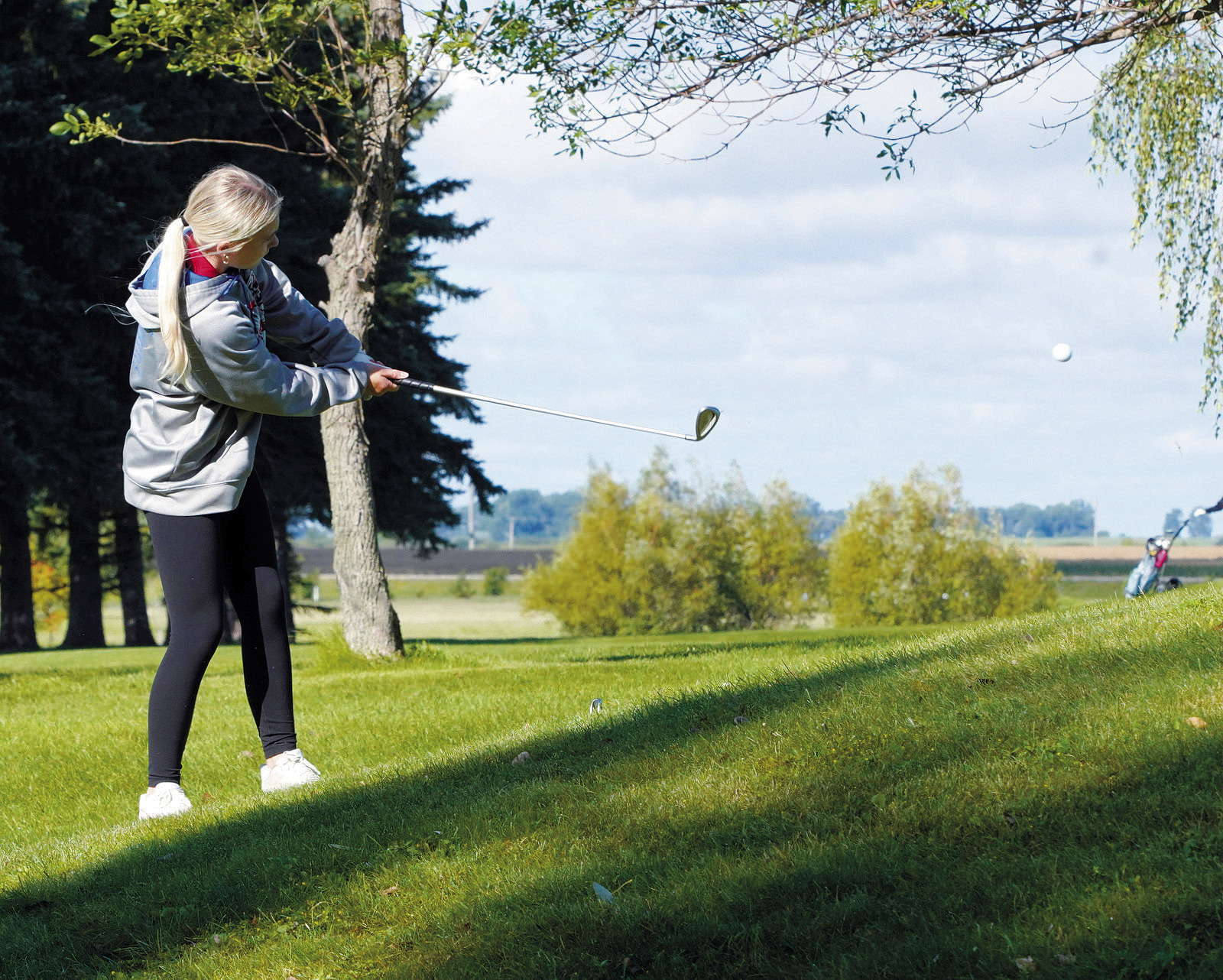 Catelyn Goodman with a chip shot to put the ball close to the hole at the Lakota Meet. Photo by Larry Stokke.