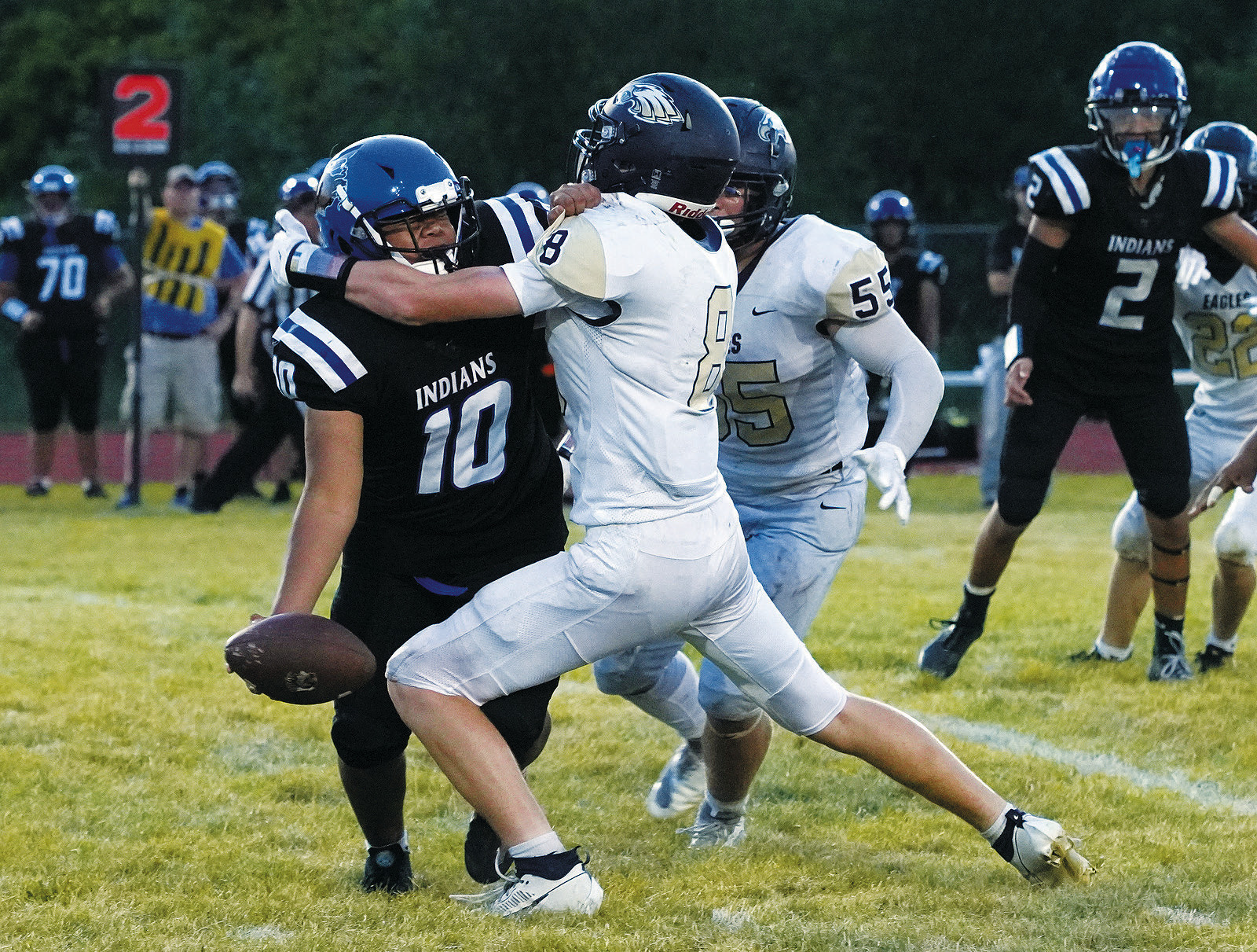 Garrett Willits and Gavin Symington team up to tackle freshman QB Kaleb Keja in the season opener against Four Winds. Photo by Larry Stokke.