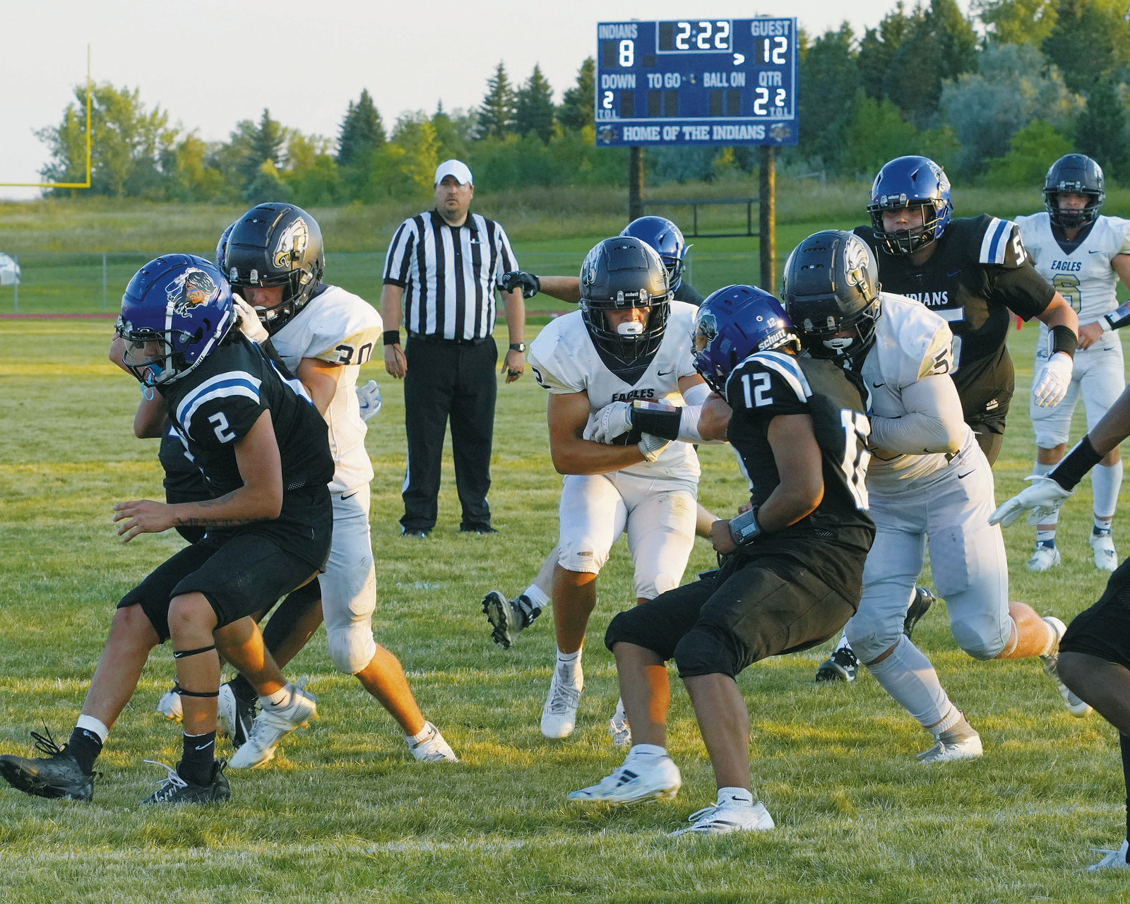 Eagles teammates Brody Berg and Gavin Symington open up a hole for Weston Cosley to run through and score a touchdown. Photo by Larry Stokke.