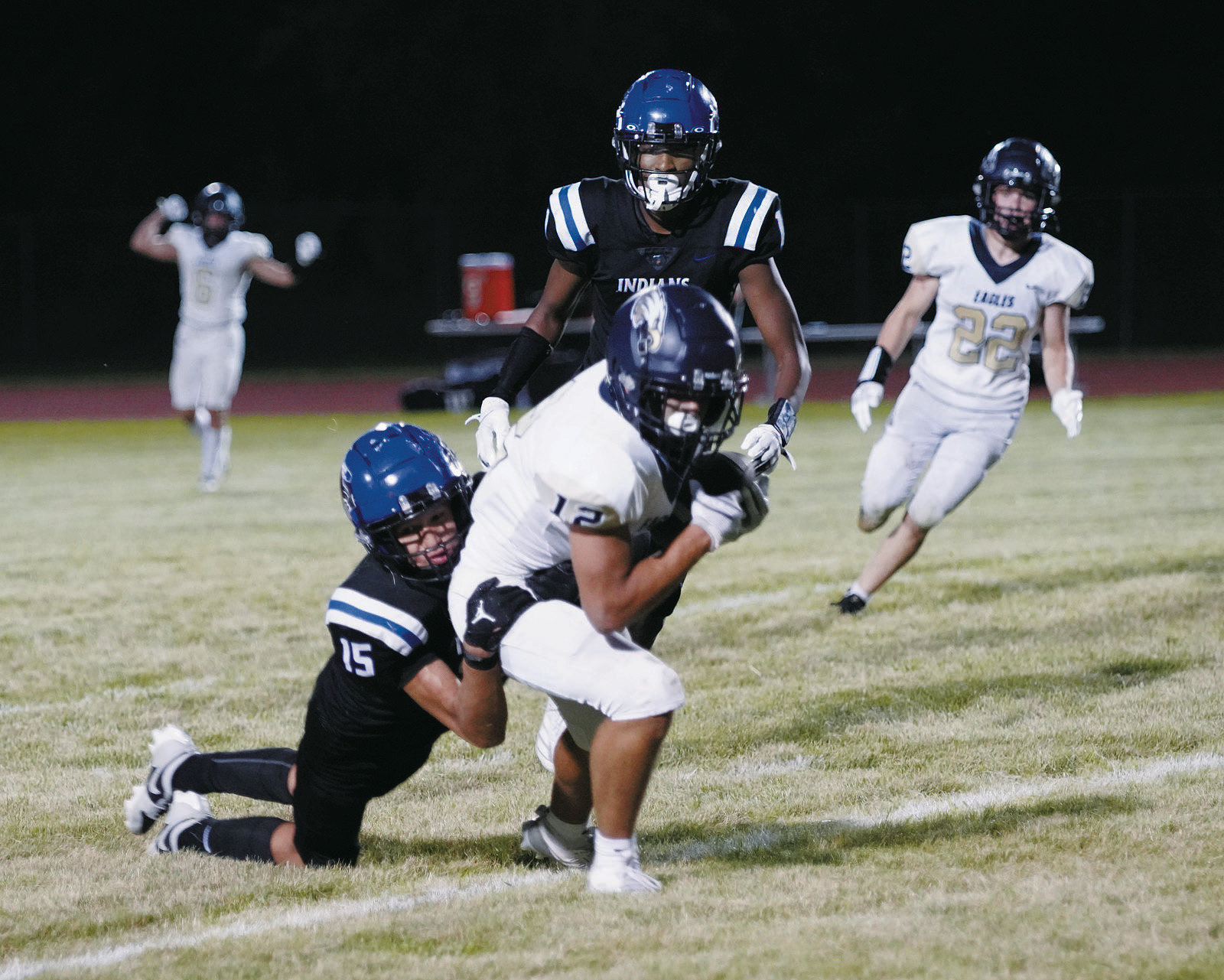 Weston Cosley drags a 4 Winds player with him as he scores a TD for the Eagles. Photo by Larry Stokke.