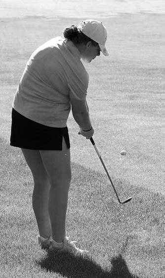 Stella Busse chips her ball onto the green by the cup. Photo by Larry Stokke.