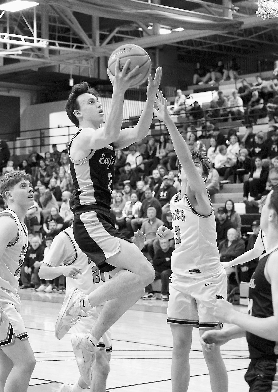 Kaden Moore drives in and lays up a basket during the win over MPCG at Regionals in Devils Lake on March 10. Photo by Larry Stokke.