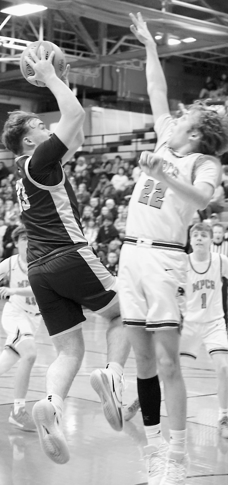 Kade Schafer puts up a shot over the Patriots’ Bricker Johnson. Photo by Larry Stokke.
