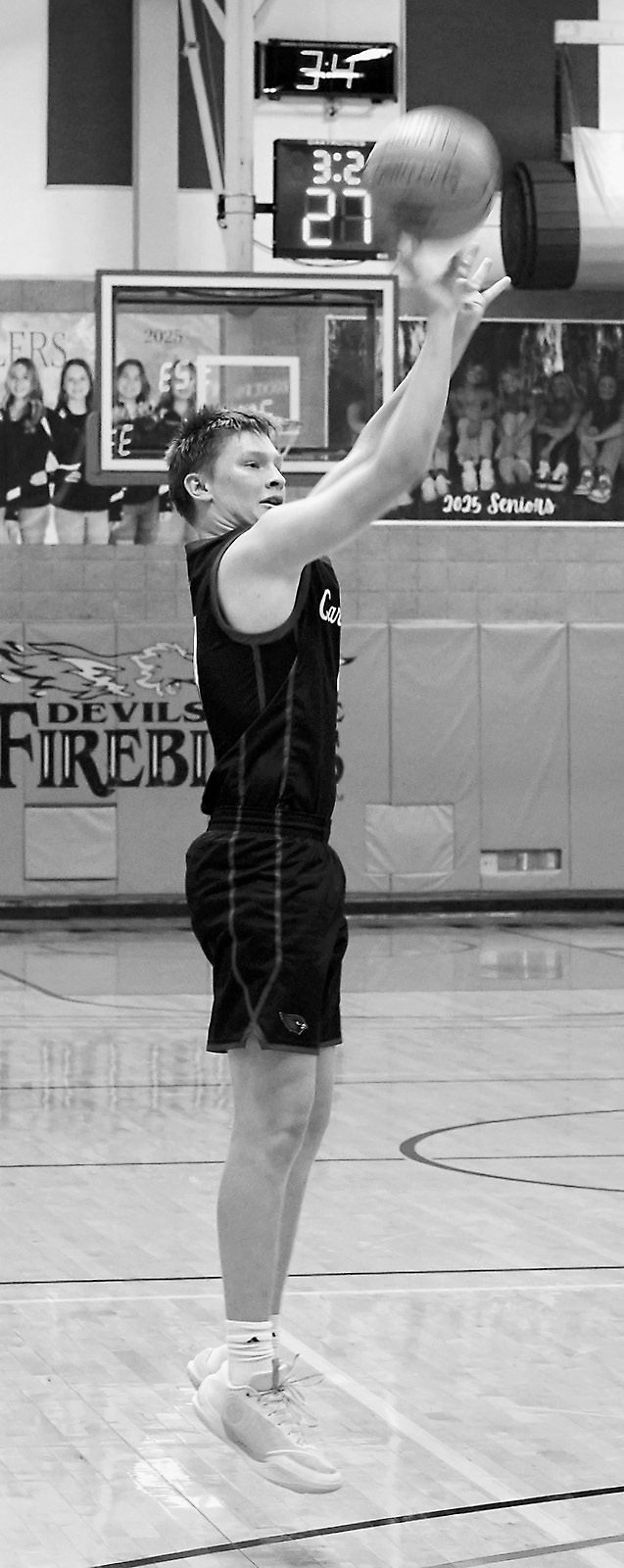 Levi Swanson drains a 3-point shot against NR-S in the first round of Regionals. Photo by Larry Stokke.