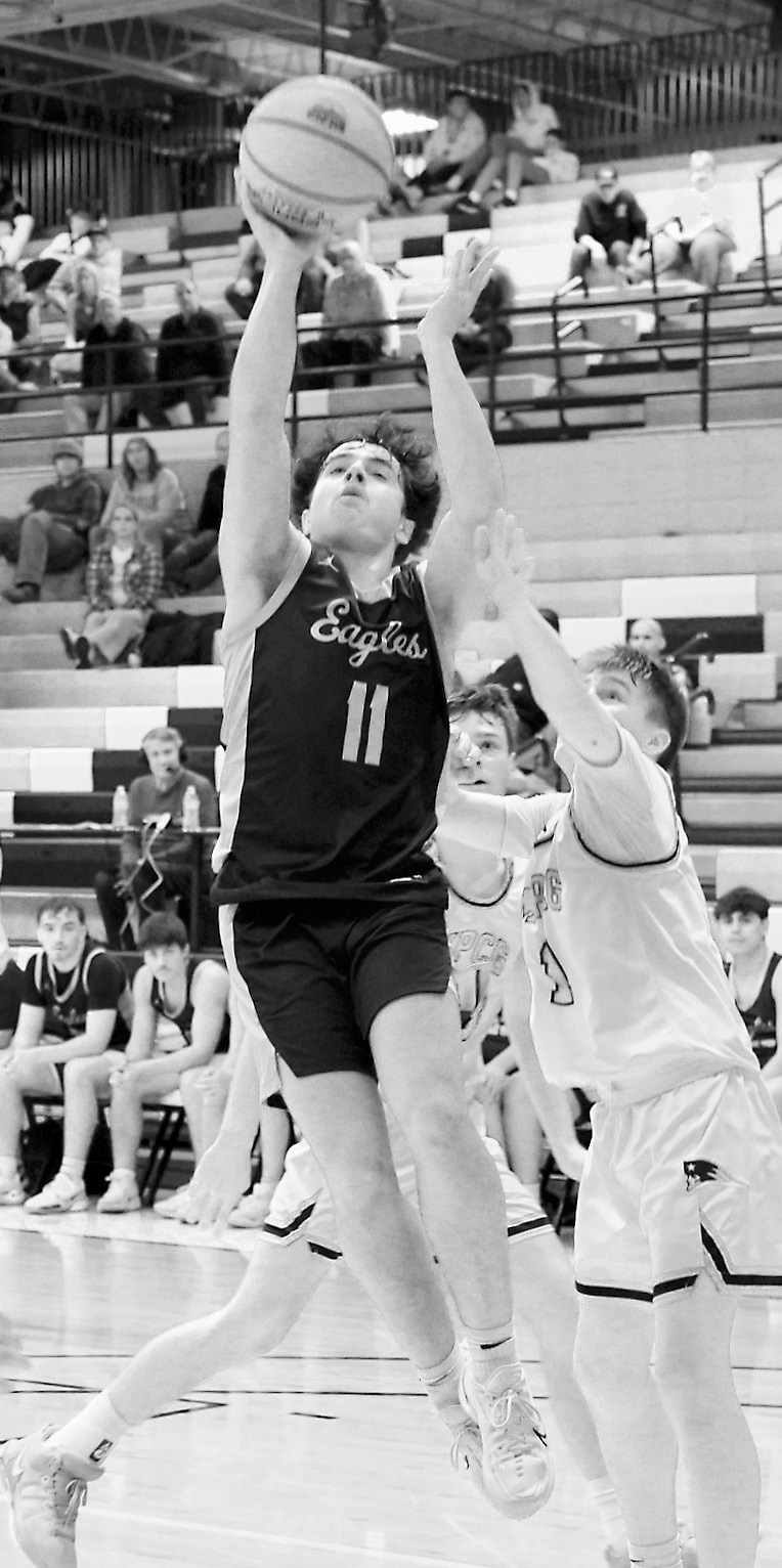 Grant Cosley sinks a shot, finishing with a game high of 23 points in the Eagles' win over MPCG to move on in the Region Tournament. Photo by Larry Stokke.