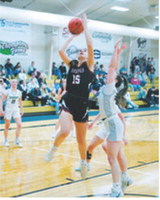 Taya Feist drops in a right-handed layup and finished the game with 10 points. Photo by Larry Stokke