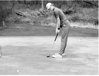 Bjorn Evenson watches his putt drop into the cup during the Larimore meet on May 15. Evenson finished the day with an 87 to place 14th overall. Photo by Larry Stokke