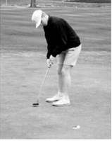 Zeke Symington sinks a putt during the Larimore meet on May 15. Photo by Larry Stokke