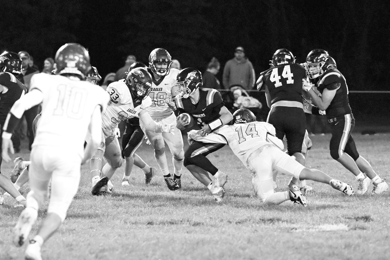 Colton Bailly (14) making a tackle with help from Chase Mench (48) and Kade Schafer (33). Photo by Ashley Schafer.