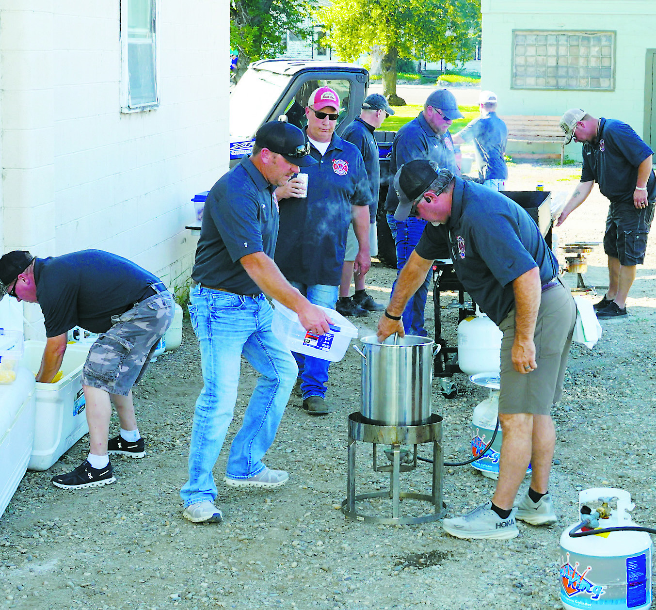 Firefighters preparing the fixin's for the annual Corn and Sausage Feed. Photo by Larry Stokke.