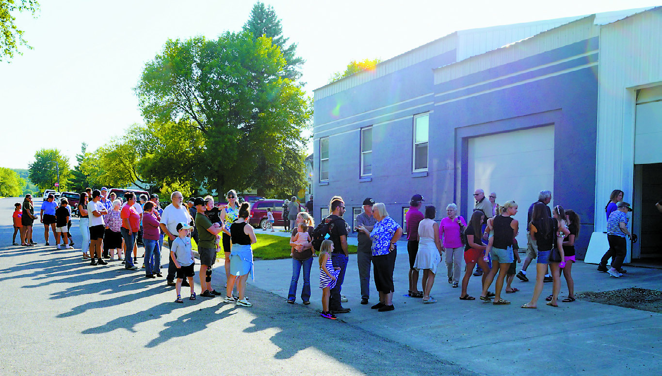Firefighter Mike Cook said they were a bit alarmed when folks began lining up around the corner, but no one left with an empty stomach! Photo by Larry Stokke.