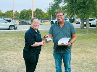 Cavalier County Farm Bureau President Paul Henderson, right, presents a $2,500 donation to Adam Westphal of the Munich Ambulance Service. Photo by Megan Overby, NDFB Northeast Field representative