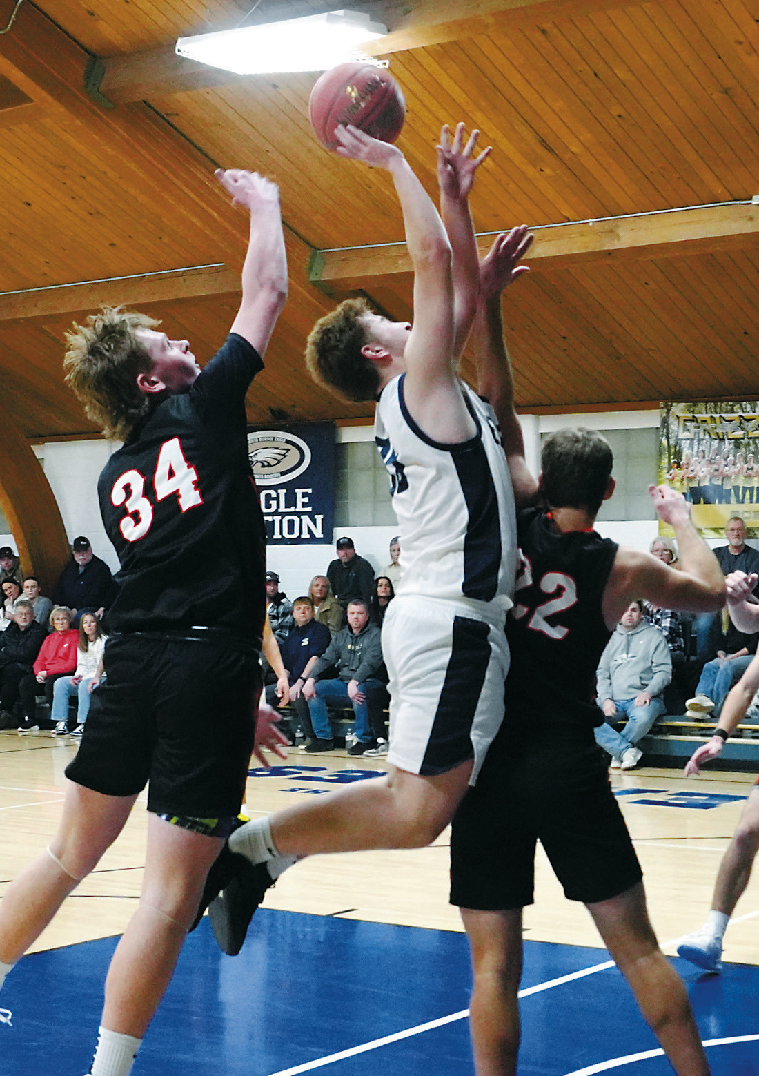 Preston Emerson gets fouled while going in for a layup, then drops in two free throws. Photo by Larry Stokke.