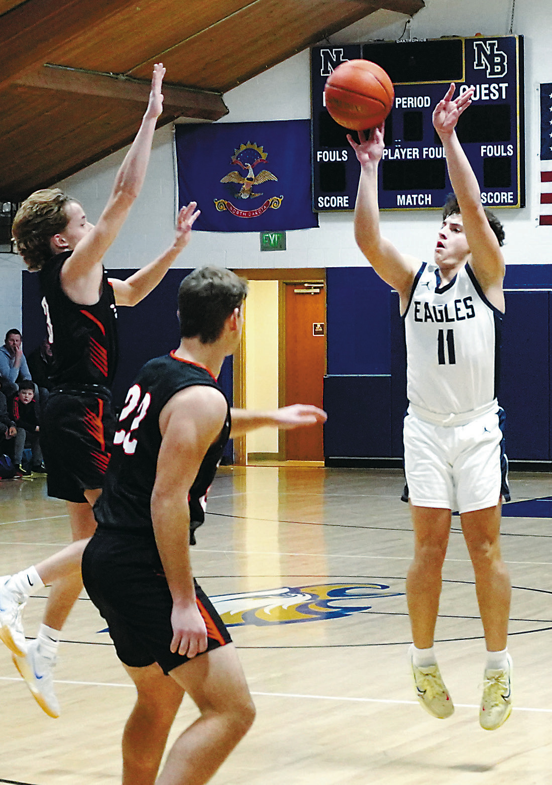 Grant Cosley nails a long three point shot to finish the win over Larimore with 15 points. Photo by Larry Stokke.