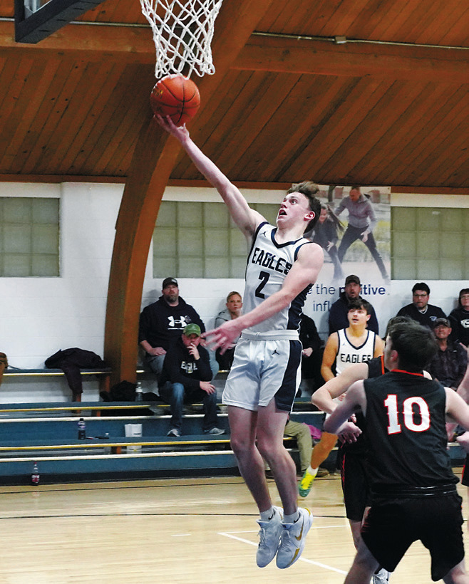 Kaden Moore rolls in a layup and finishing with a game high of 23 points in the Eagles' win over Larimore. Photo by Larry Stokke.