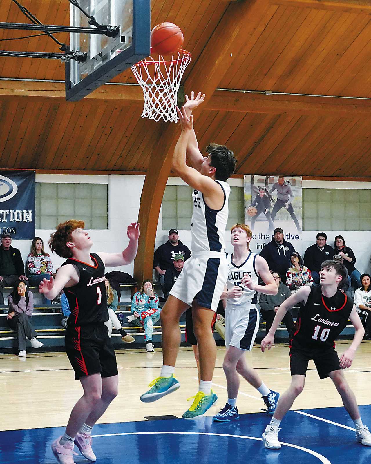 Weston Cosley drives the lane and lays in two points against the Polar Bears. Photo by Larry Stokke.