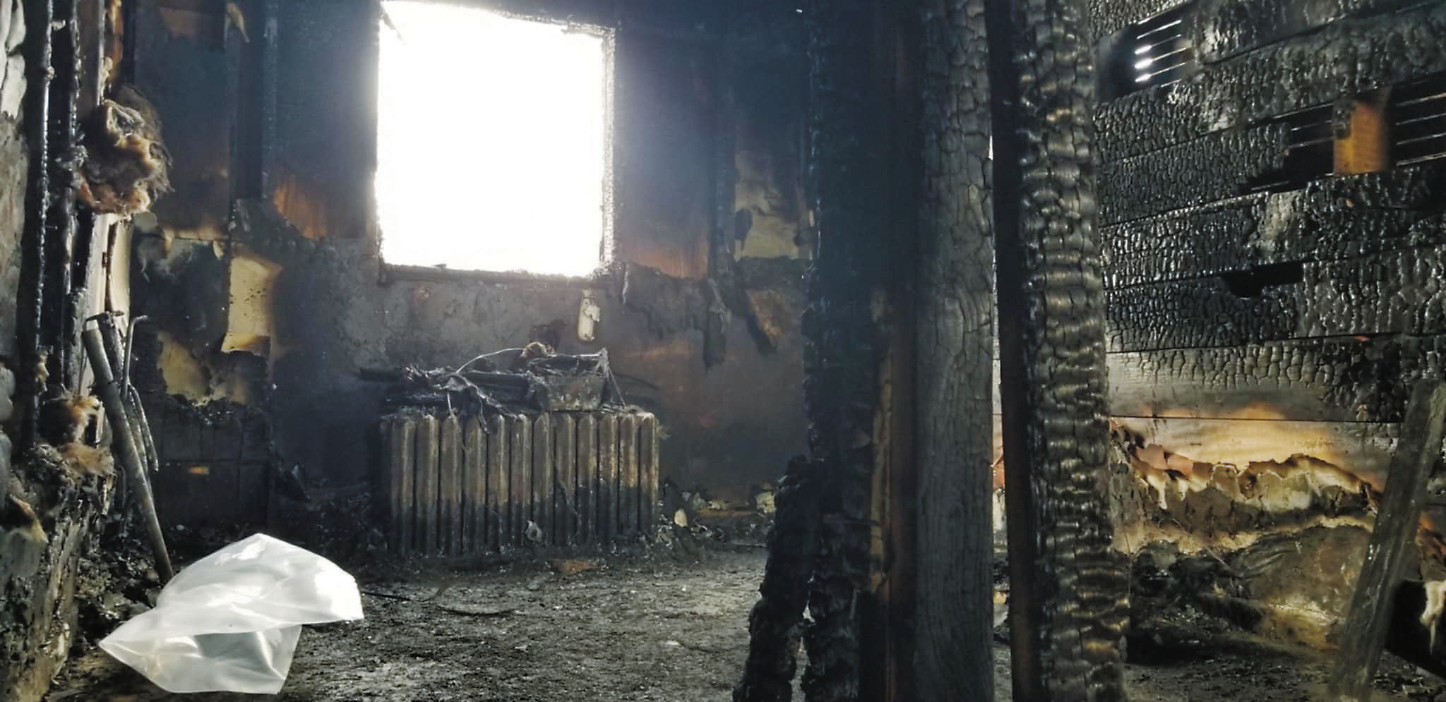 The scorched interior of the apartment building which caught fire Sunday, Feb. 23 and has left one man in critical condition. Photo by DJ Bartley.