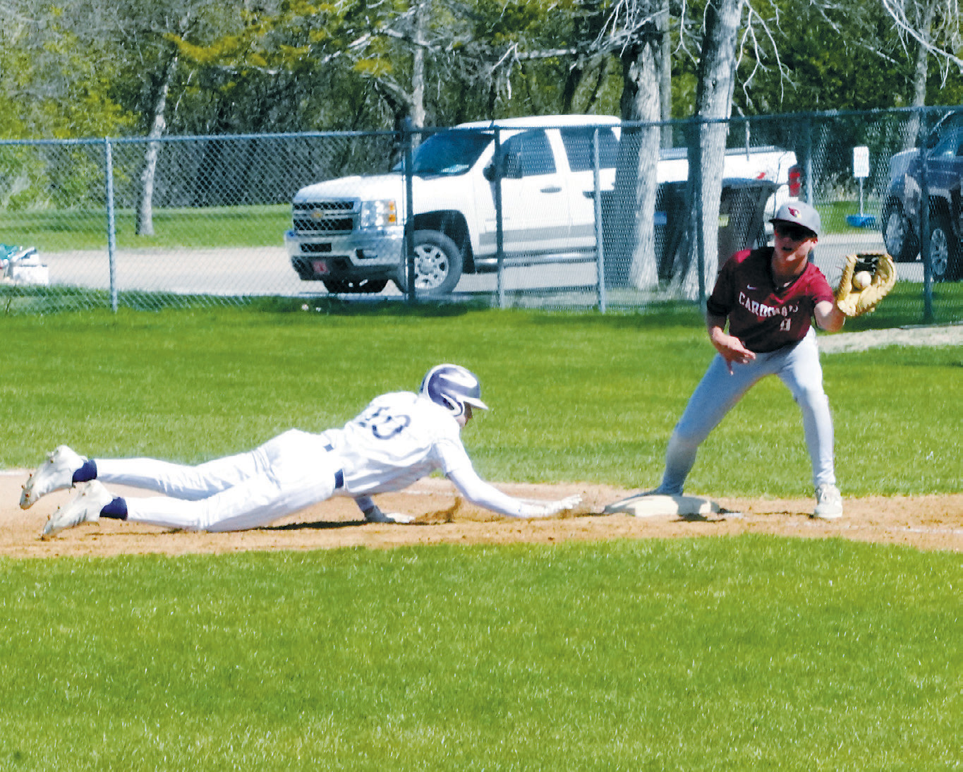 Dawson Downs puts out the Bottineau player trying to get back to first base with a great catch. Photo by Larry Stokke.