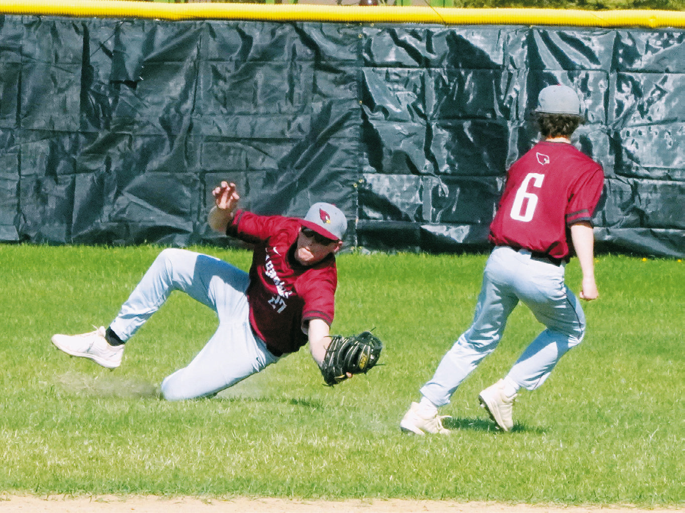 Luke Gilseth makes a diving catch in the outfield to end an inning against Bottineau. Photo by Larry Stokke.