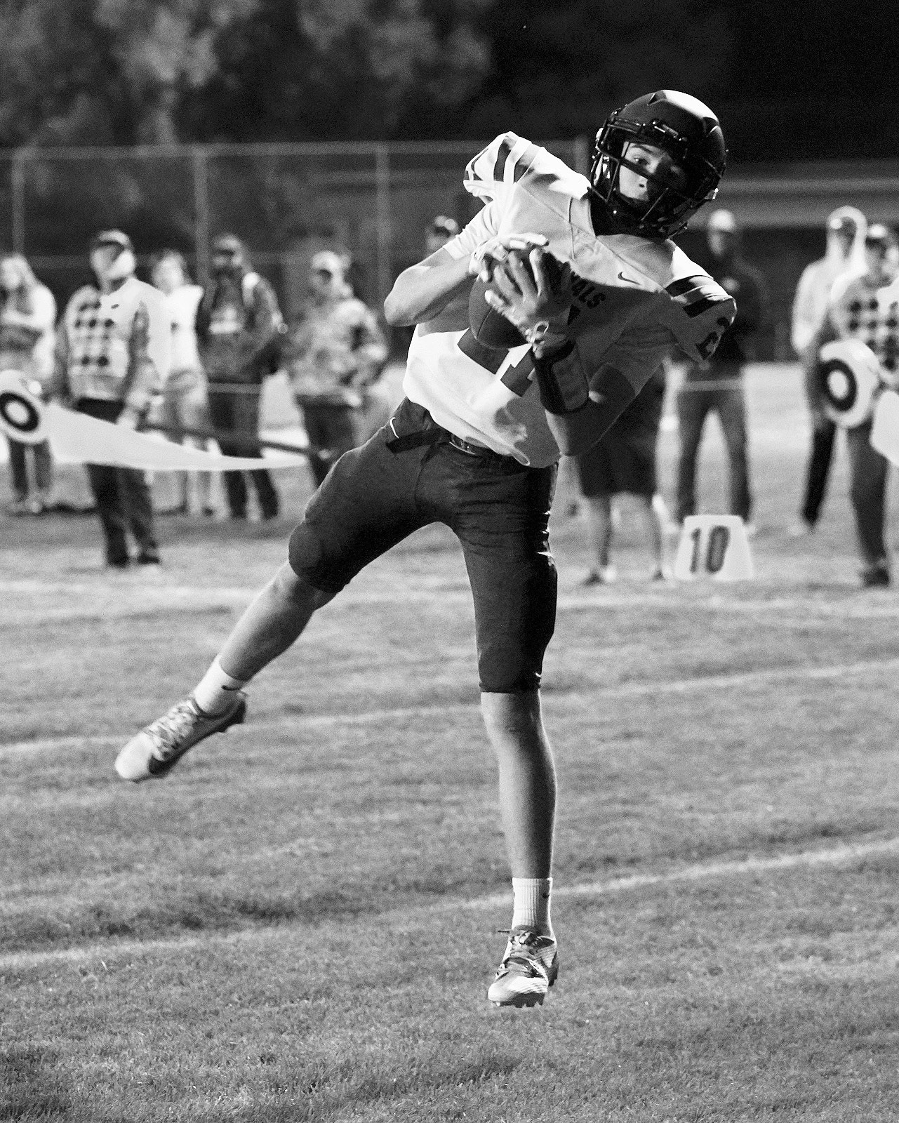 Eastyn Schaefer scores a 2 point conversion to put the Cards ahead of the Hornets for the win. Photo by Larry Stokke.