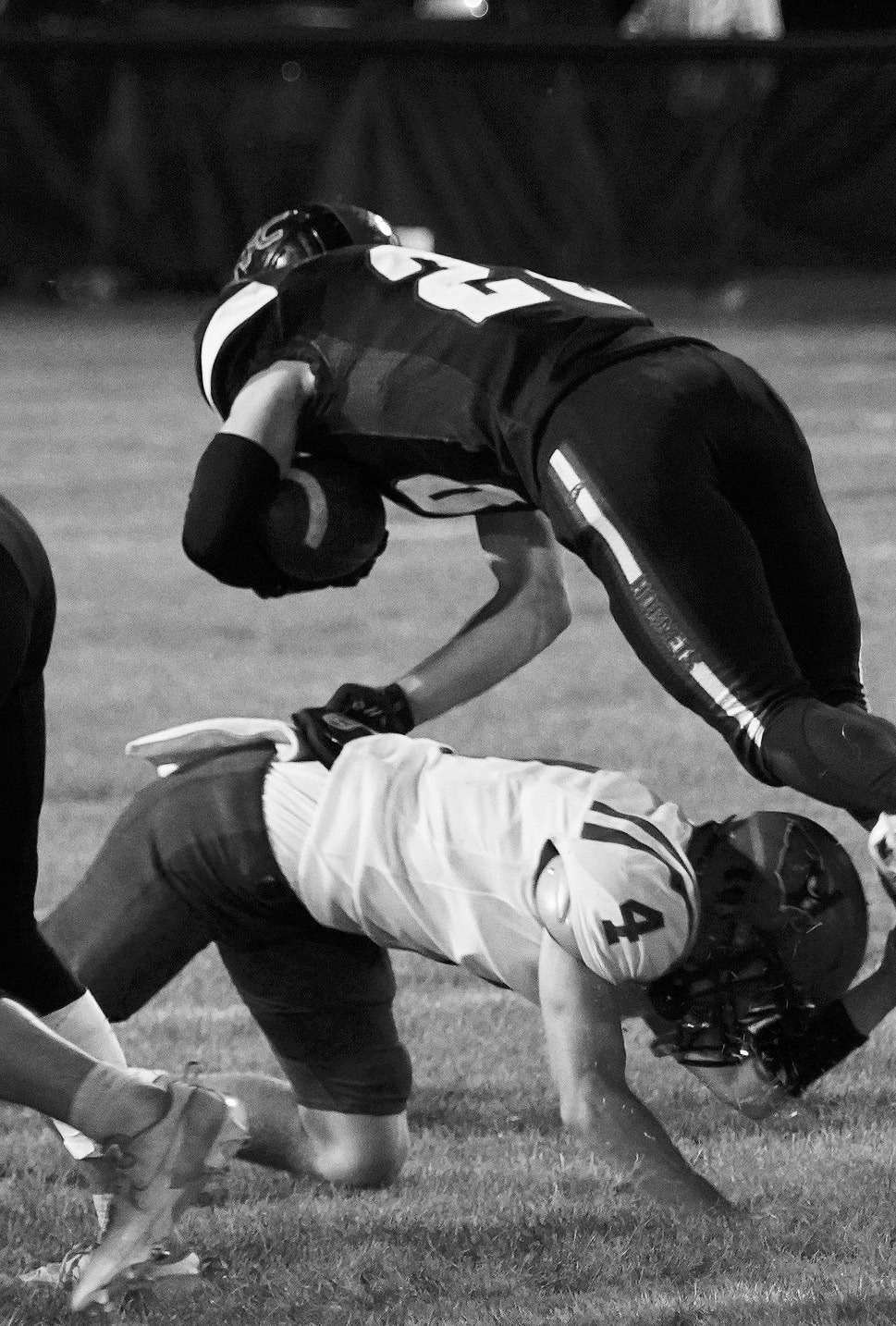 Sam Davis takes the feet out from under a Harvey player, stopping a gain in yardage for the Hornets. Photo by Larry Stokke.