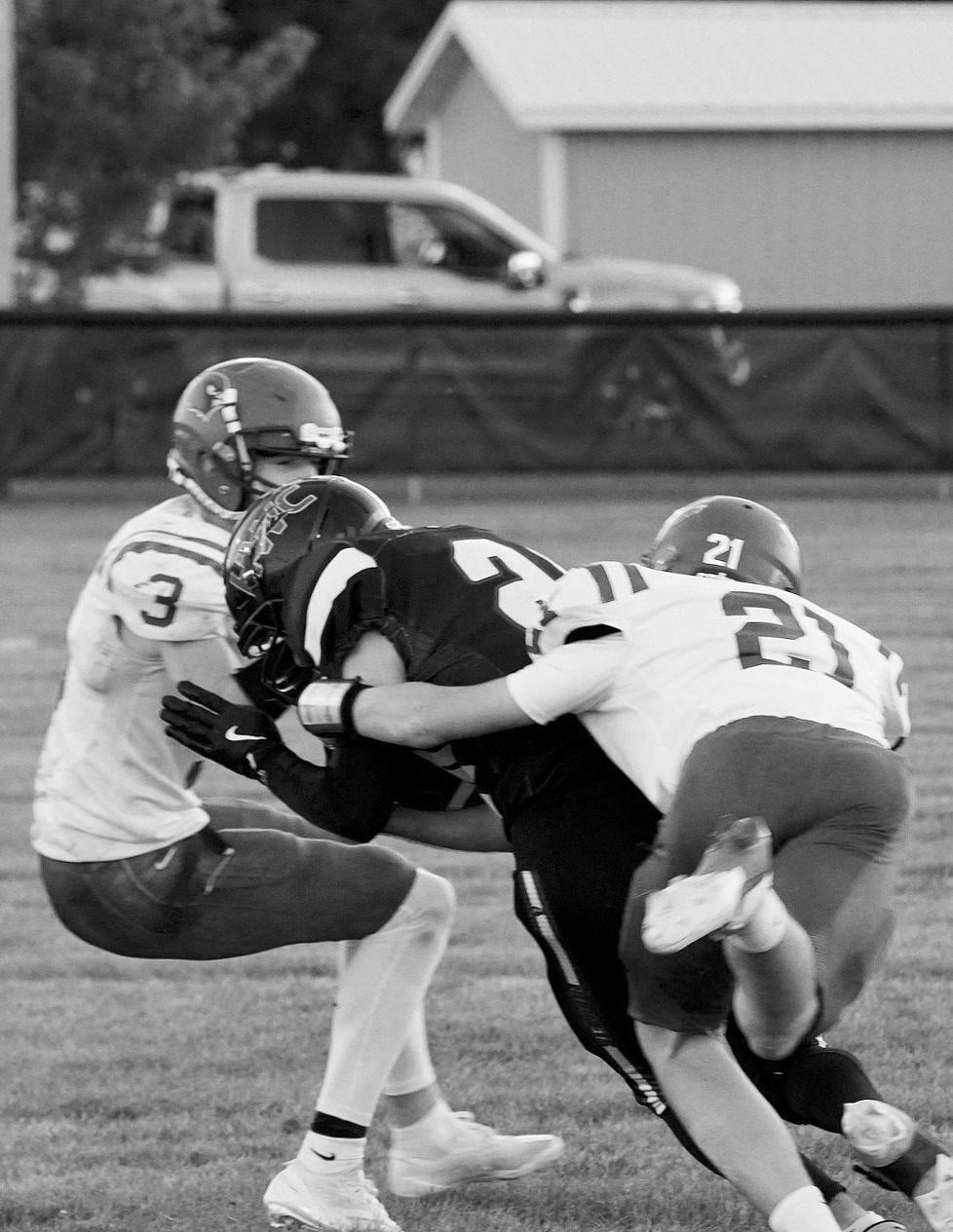 Eastyn Schaefer and Cody Amble team-up to tackle a Hornets ball carrier. Photo by Larry Stokke.