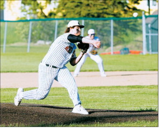 Theo Romfo delivers a strike during Langdon Area/Munich’s victory over Grafton on June 11. Photo by Larry Stokke