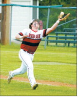 Devin Hakanson races into the outfield and makes the catch on a pop fly for an out against Carrington. Photo by Larry Stokke