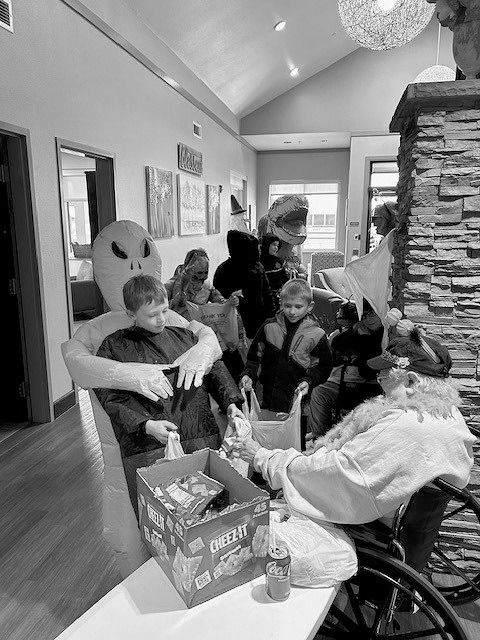Kids trick or treating through Pembilier Nursing Center.