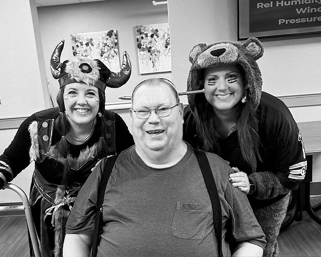 Kelsey, Richard, and Heather pose for a photo while celebrating Halloween.