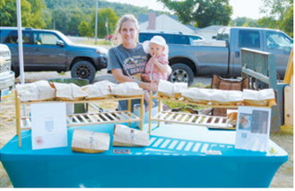 A sourdough stand offers a variety of freshly baked goods during the Walhalla Growers and Makers Market’s special night market Wednesday, Aug. 12. Photo by Larry Stokke