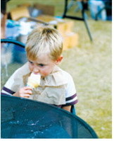 A young visitor enjoys an ice cream cone during the Walhalla Growers and Makers Market’s special night market Wednesday, Aug. 12. Photo by Larry Stokke