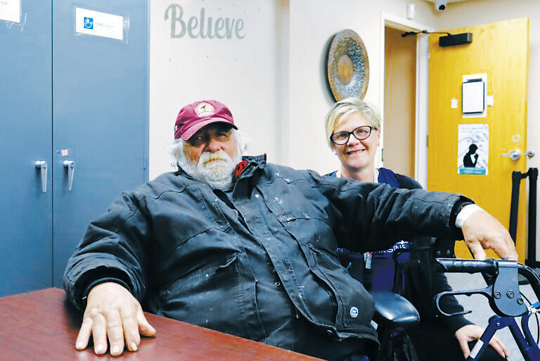 Michael Hauck, 64, left, a homeless veteran, sits next to Kris Morrissette, behavioral health manager at Ministry on the Margins in Bismarck, before being transported to a nearby hotel as he awaits approval to move into a nearby apartment on Nov. 6, 2025. (Photo by Michael Achterling/ North Dakota Monitor)