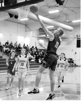 Maddux Stremick finger rolls the ball in for two points. Photo by Larry Stokke
