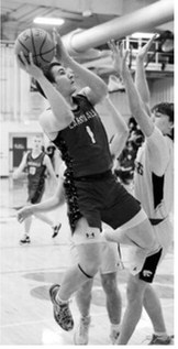 Eastyn Schaefer attacks the basket and drops in two points in the win over North Prairie. Photo by Larry Stokke