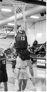 Caleb McDonald leaps up and drops the ball over the rim for two points in the win over North Prairie. Photo by Larry Stokke