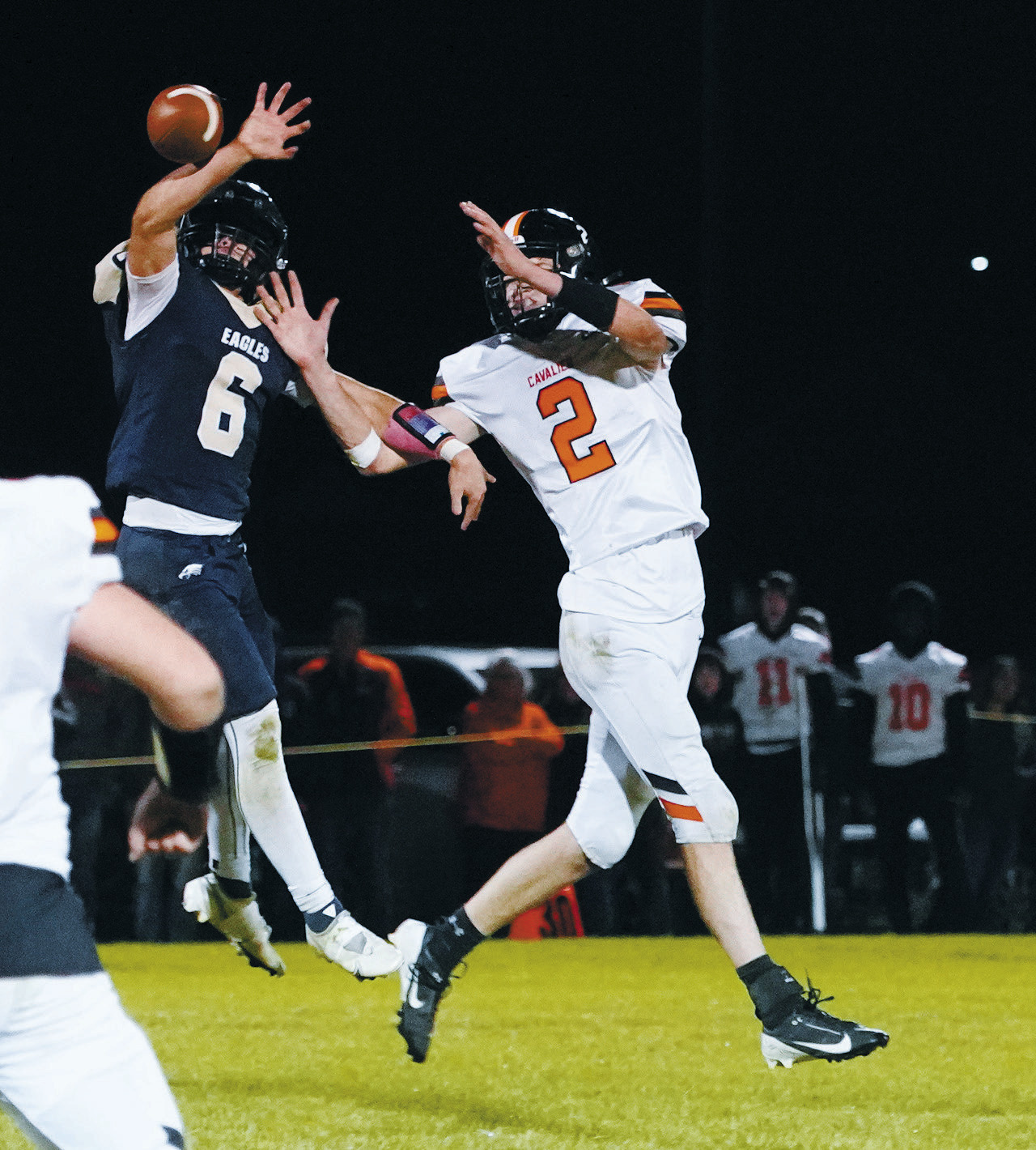 Grant Cosley breaks up an attempted pass to Ryan Pelletier. Photo By Larry Stokke.