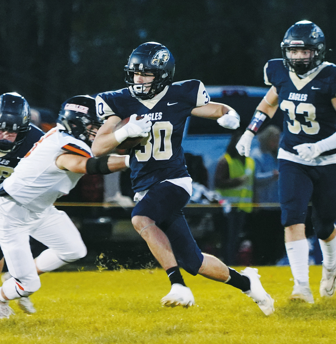 Brody Berg carries the ball for a first down in the Eagles win over the Tornadoes. Photo by Larry Stokke.
