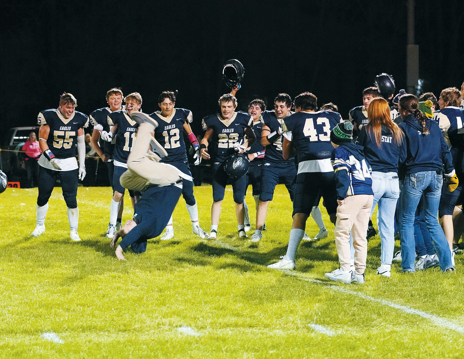 Crag Brodeur does a victory roll into the Eagles huddle after the win over the Tornadoes. Photo by Larry Stokke.