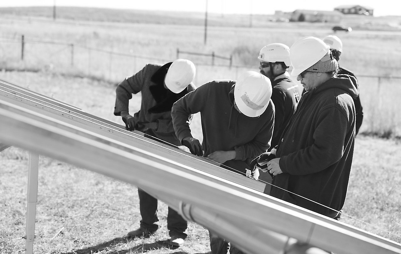 Indigenized Energy technicians work to erect a ground-mounted residential solar project at Pine Ridge Reservation in October 2024. Around 30 trainees from the tribe participated, with six of those later hired by a contractor taking part in the project. Photo provided. Photo provided