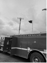 Picture with light tower extended: The truck's 30-foot telescoping light tower is extended for nighttime field work.