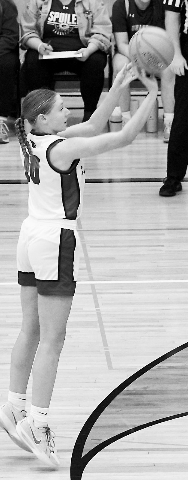 Aubrey Badding eyes the basket and sinks a 3-pointer in the Cards' game against Grafton. Photo by Larry Stokke.