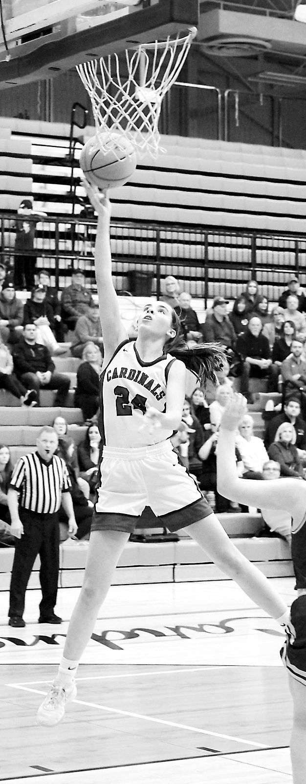 Avery Lorenz drives into the lane and drops in a basket, finishing the game against Grafton with 11 points. Photo by Larry Stokke.
