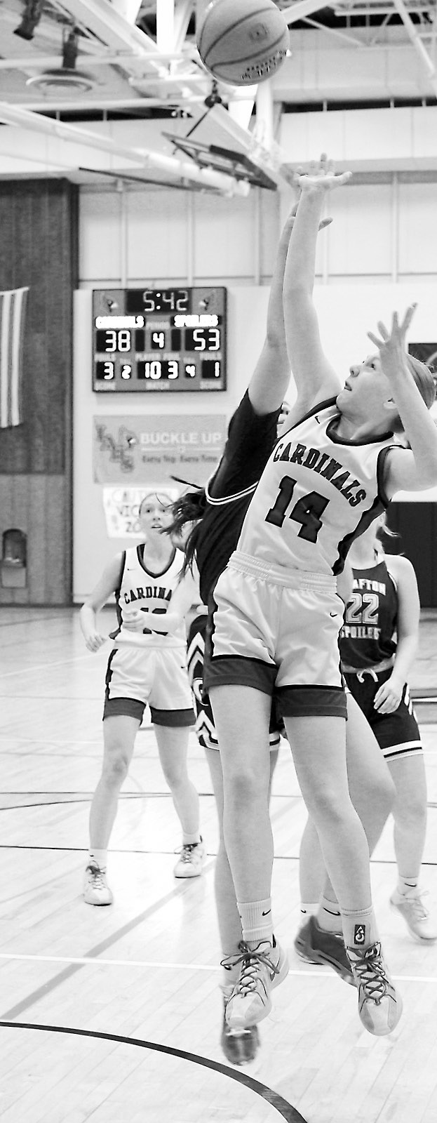 Hilary Haaven drops in a basket while under pressure from a Grafton Spoiler. Photo by Larry Stokke.
