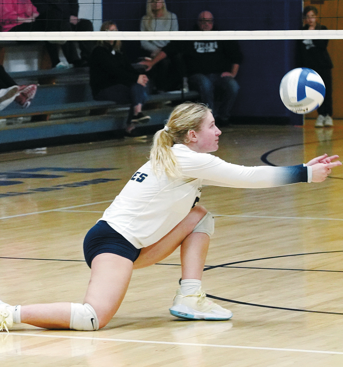 Adrienne Longtin sets the ball to a teammate against the Titans. Katelyn Bjornstad with a dig against the Titans. Photo by Larry Stokke. Photo by Larry Stokke.