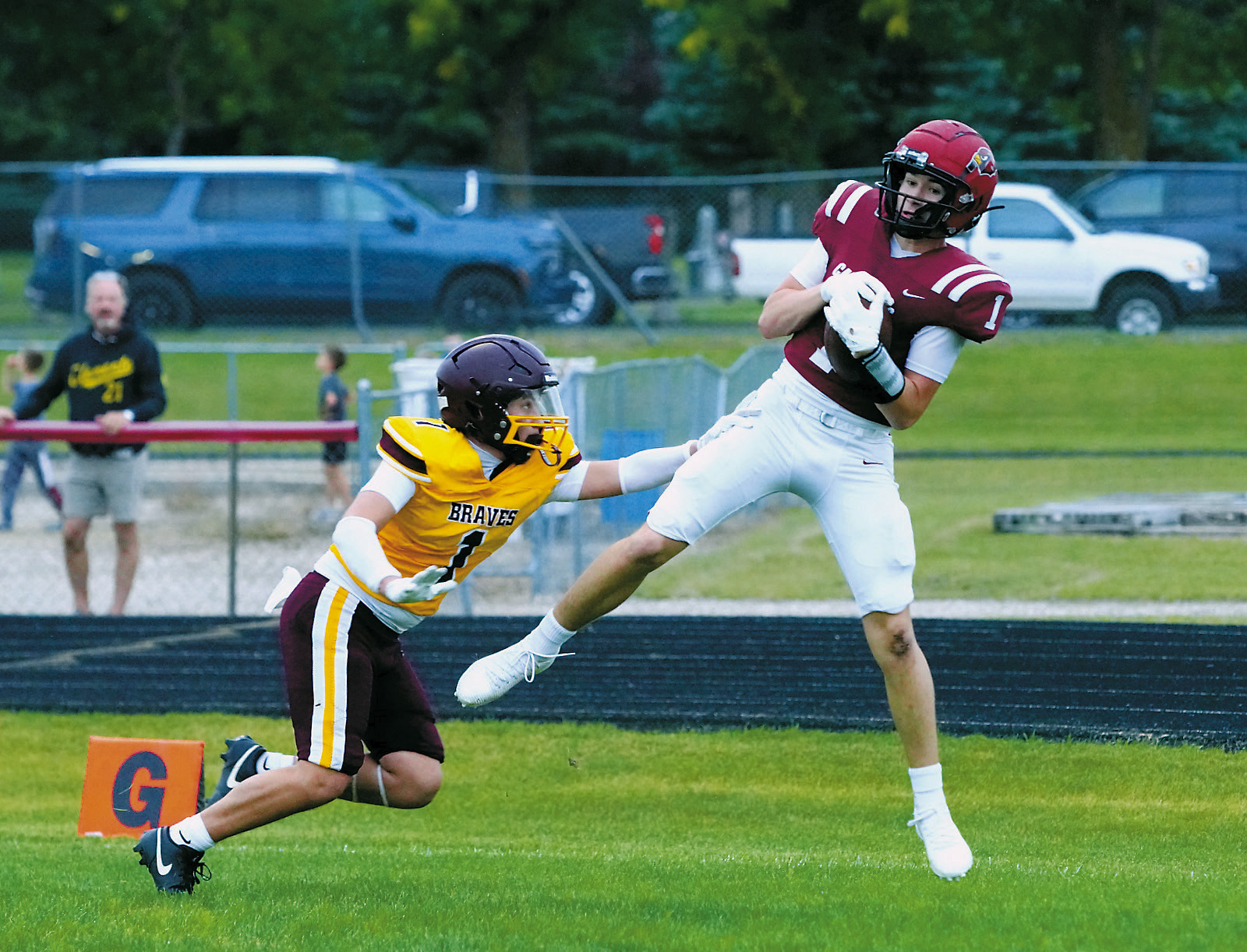 Eastyn Schaefer catches a 33-yard pass to get a touch down for the Cardinals. Photo by Larry Stokke.
