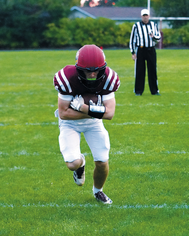 Keaton Ullyott , who was Player of the Game in the win over the Braves, crosses the goal line to add six points to the Cards' score. Photo by Larry Stokke.