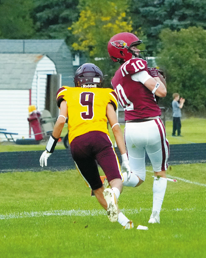 Maddux Stremick with a great reception to get the Cardinals down close to the goal line. Photo by Larry Stokke.
