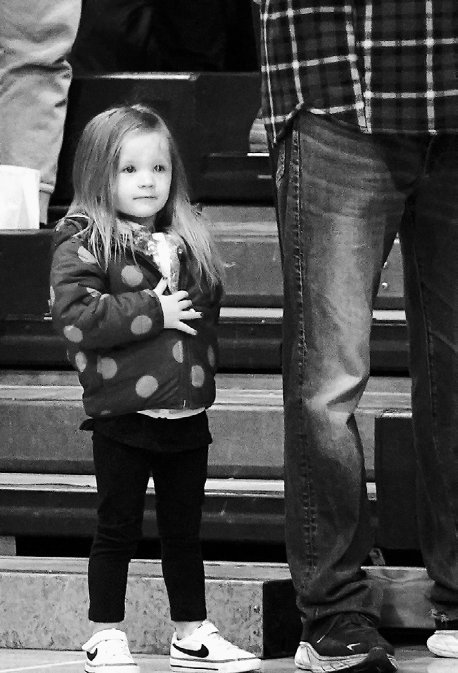 Hadley Mathison showing her respect for the flag at the NB kids wrestling meet. Photo by Larry Stokke